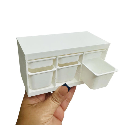 White 6-drawer storage bin held in a hand against a white background