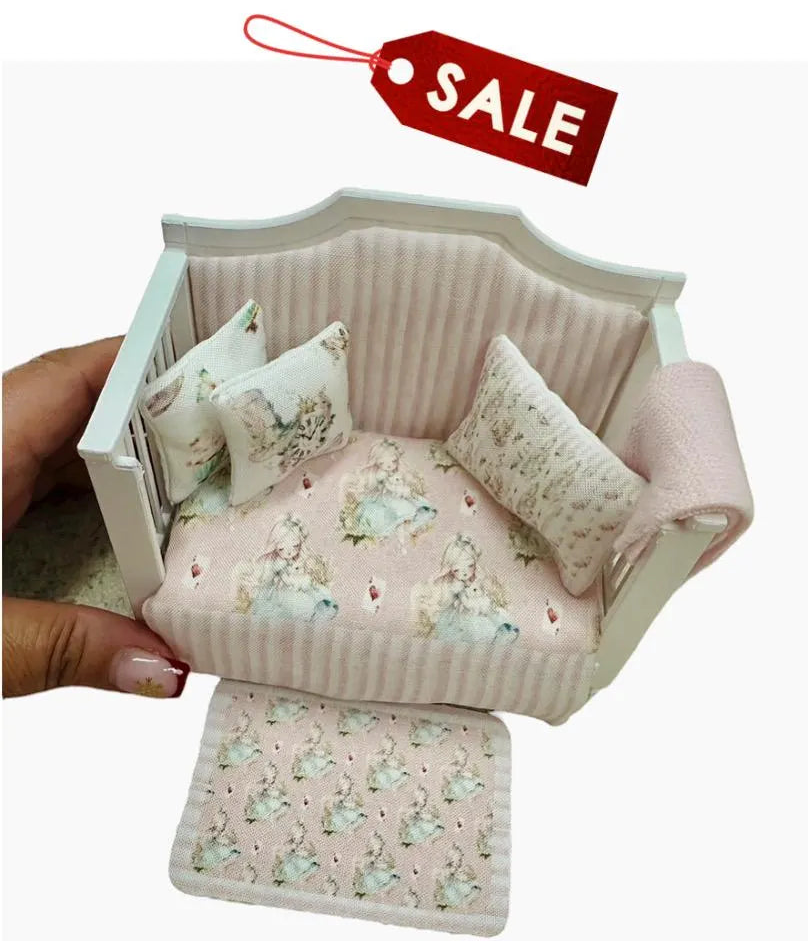 Miniature dollhouse daybed with floral patterns and cushions, held by a hand, on a white background with a red 'SALE' tag.
