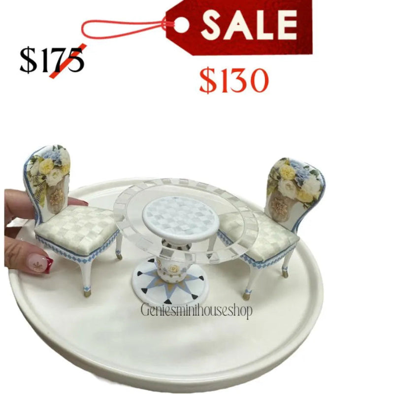 Miniature table and chairs set with a 'Sale' tag and price comparison on a white background.
