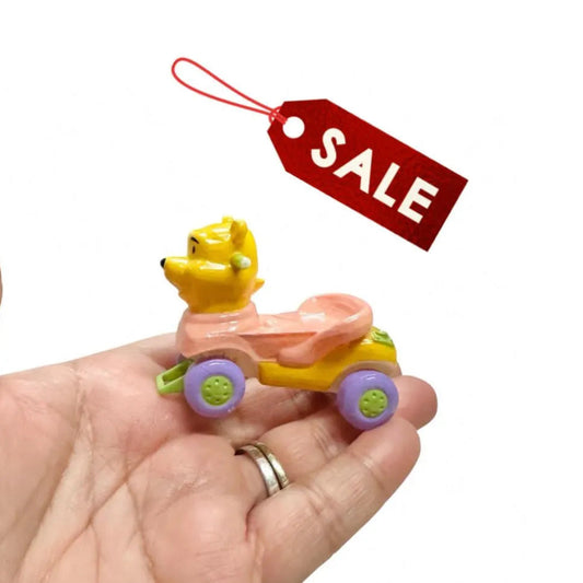 Colorful toy figure on a hand with a 'SALE' tag above it